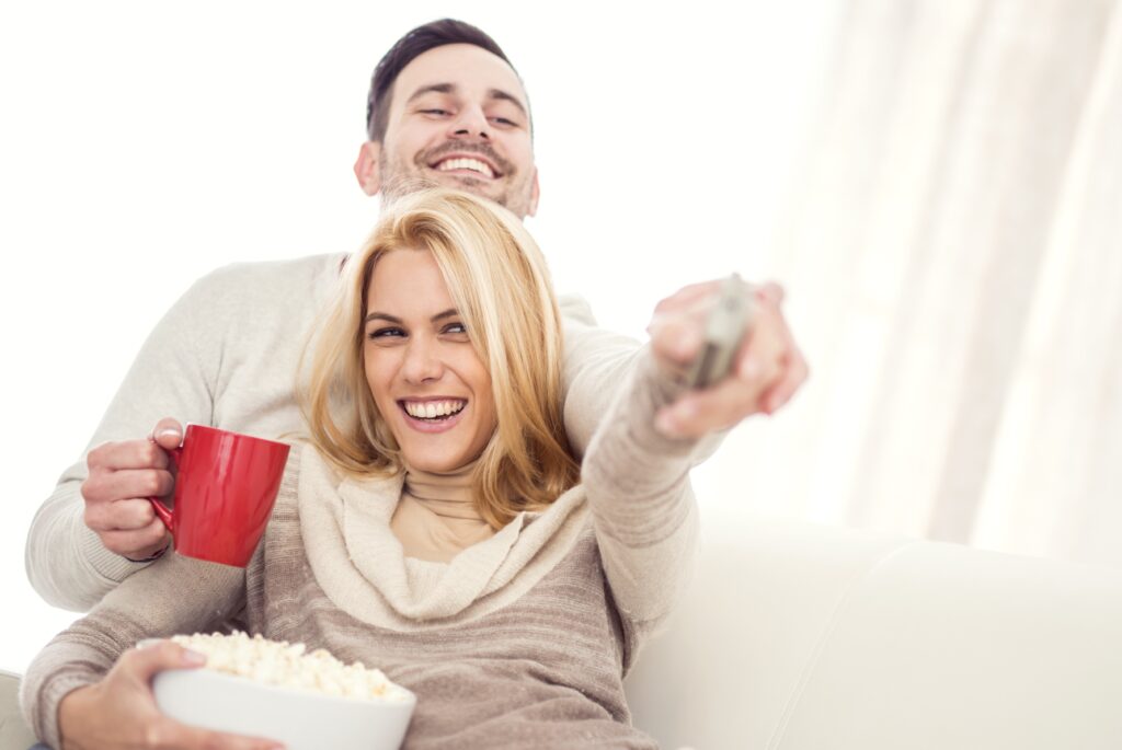 happy couple watching screen casting for hotels